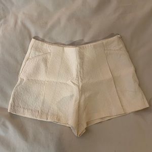 White pleated shorts